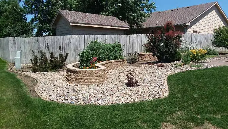 Custom stone landscaping and retaining wall in Bondurant, IA.
