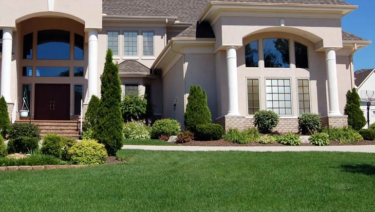 A professionally maintained lawn and landscape at a home in Grimes, Iowa.