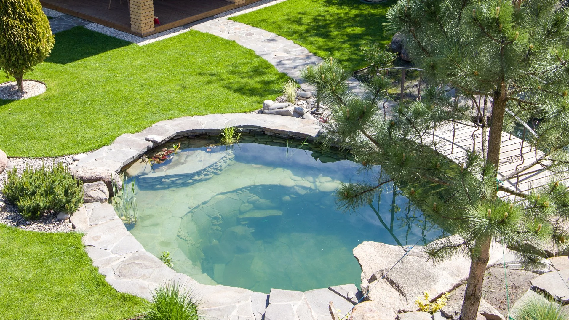 A beautiful rock waterfall professionally installed by our skilled employees at a home in West Des Moines, IA.