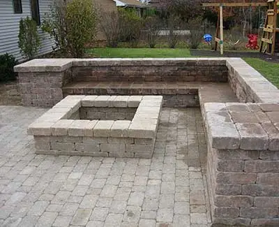 Custom fire pit and seating wall construction in Ankeny, IA.