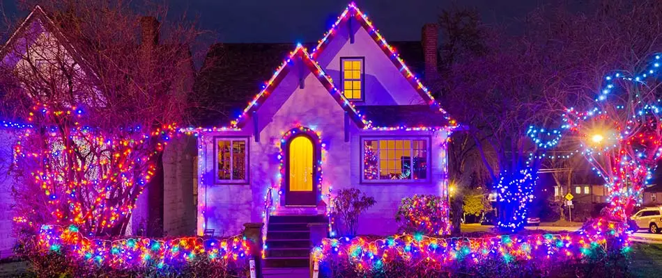 Colorful holiday lighting installed on a home in West Des Moines, IA.