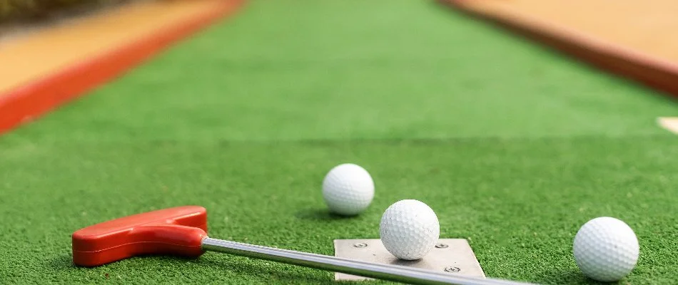 Artificial turf putting green in Des Moines, IA, with golf balls.