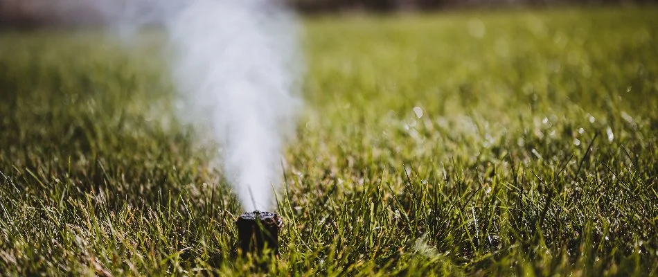 Blowing out water from an irrigation system for winterization in Cumming, IA.