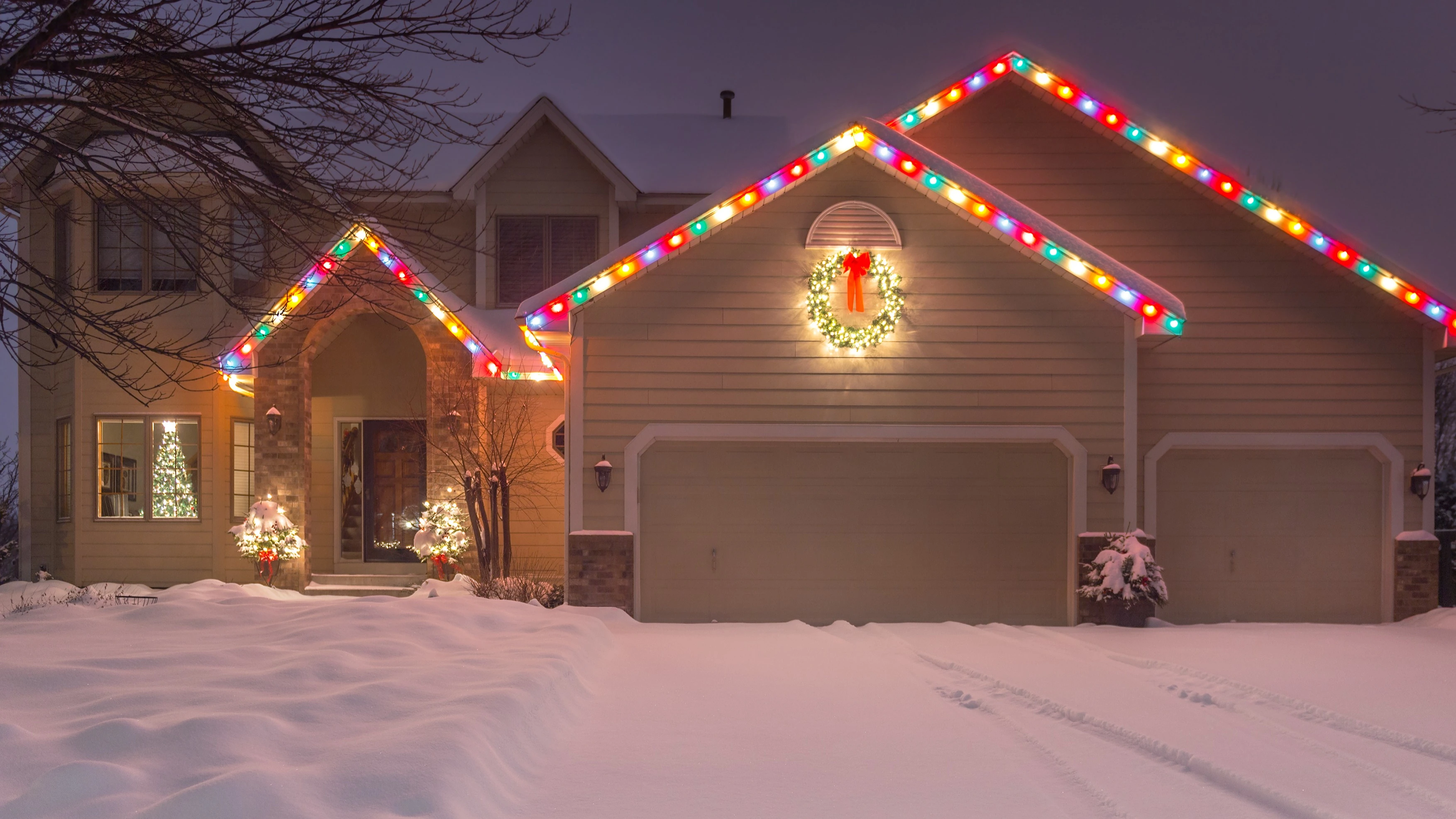 Roofline in Des Moines, IA, with white holiday lights.