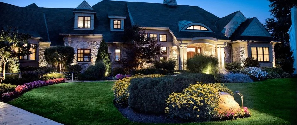 Property at night with lighting and manicured landscape in Indianola Hills, IA.