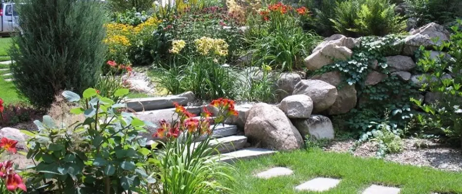 Landscaping with stone steps on a property in Lakewood, IA.