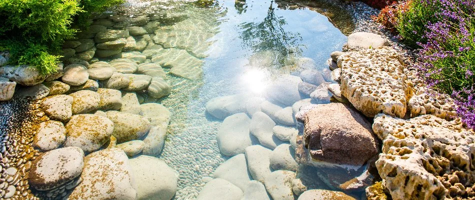 Large stones at the bottom of a clear pond in Des Moines, IA.
