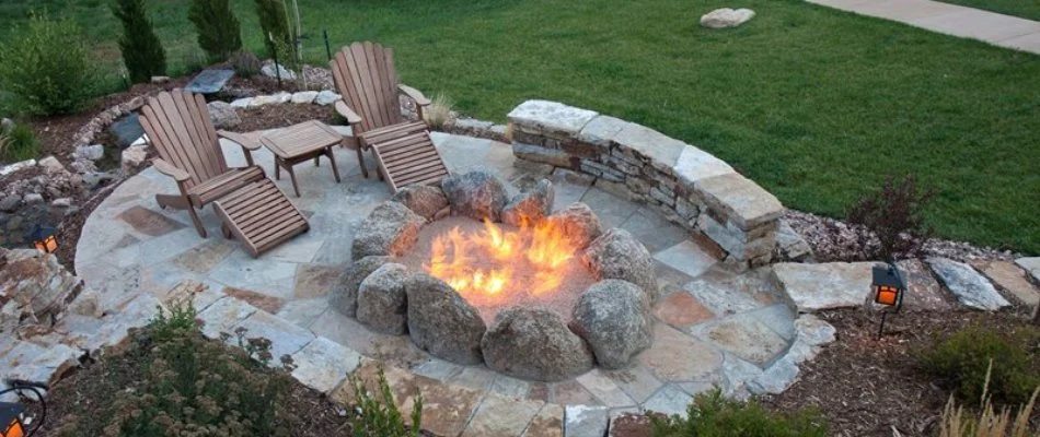 Aerial view of fire pit and patio on a property in Lakewood, IA.