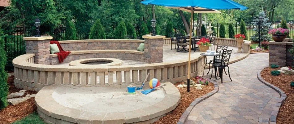 Outdoor space with patio, fire pit, seating wall, and more in Fairmont Park, IA.