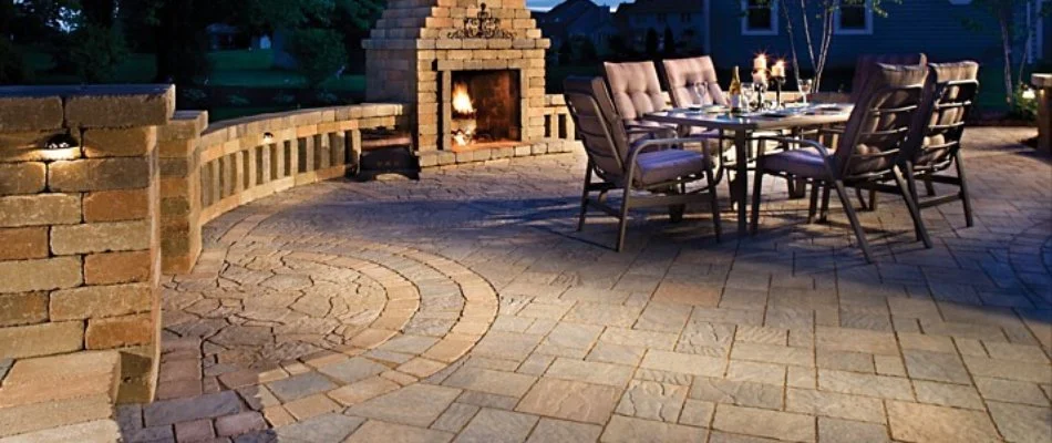 Patio with outdoor fireplace, tables, and chairs, in Cumming, IA.