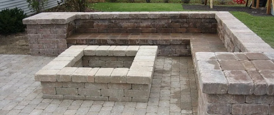 Seating wall and fire pit on a property in Indianola Hills, IA.